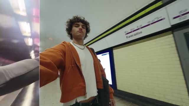 A moving-camera character shot on a station platform.