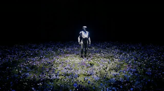 A futuristic figure walks through an illuminated field of flowers.